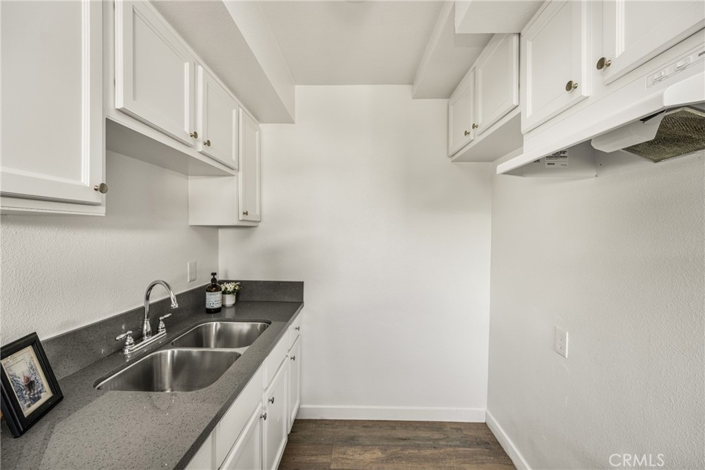 6725 Perry Road Bell Gardens, CA 90201 - Photo 24 of 40 a kitchen with stainless steel appliances granite countertop a sink and a white cabinets