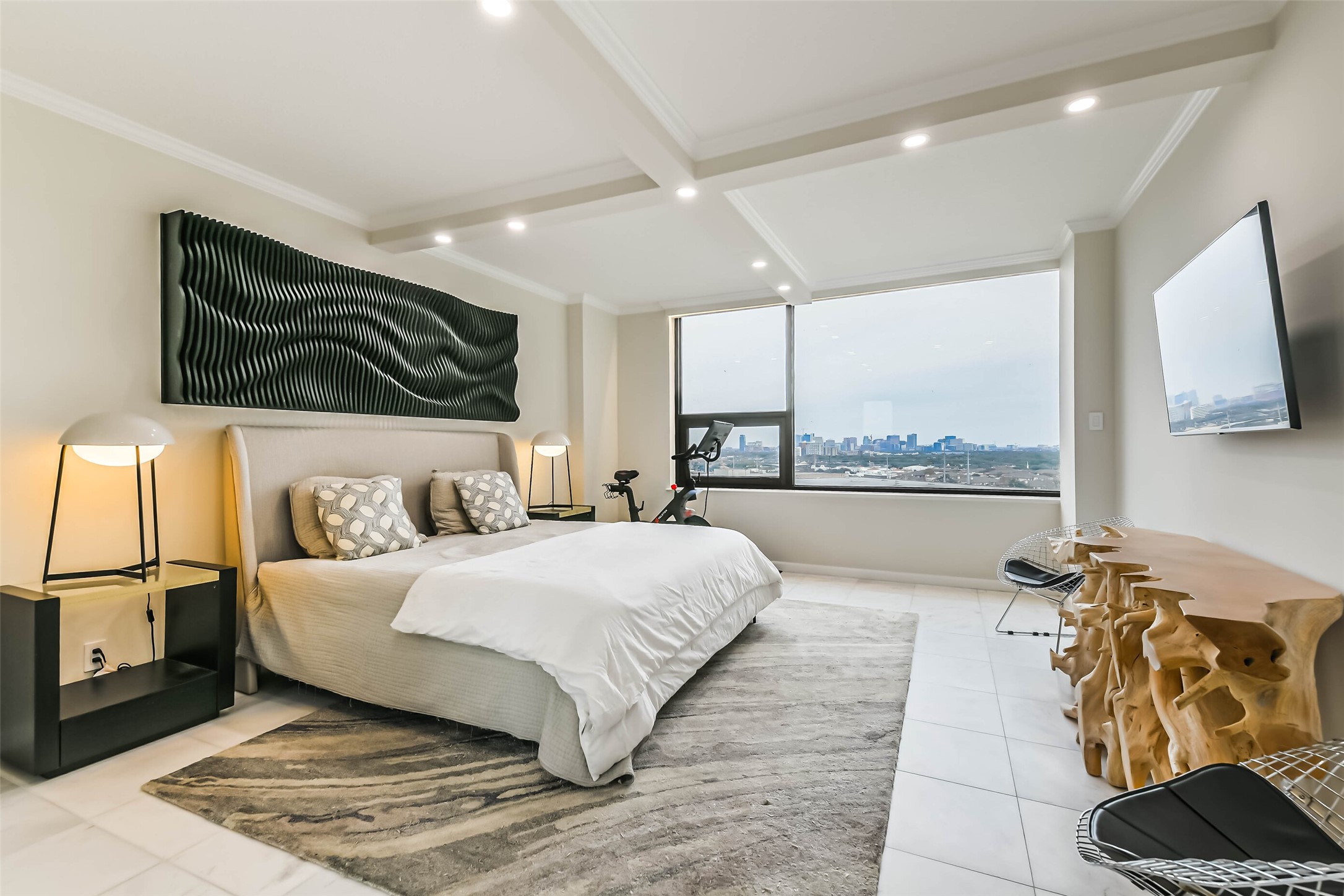 14 Greenway Plaza, Unit 15P Houston, TX 77046 - Photo 10 of 25 a bedroom with a large bed and a flat tv screen on a dresser
