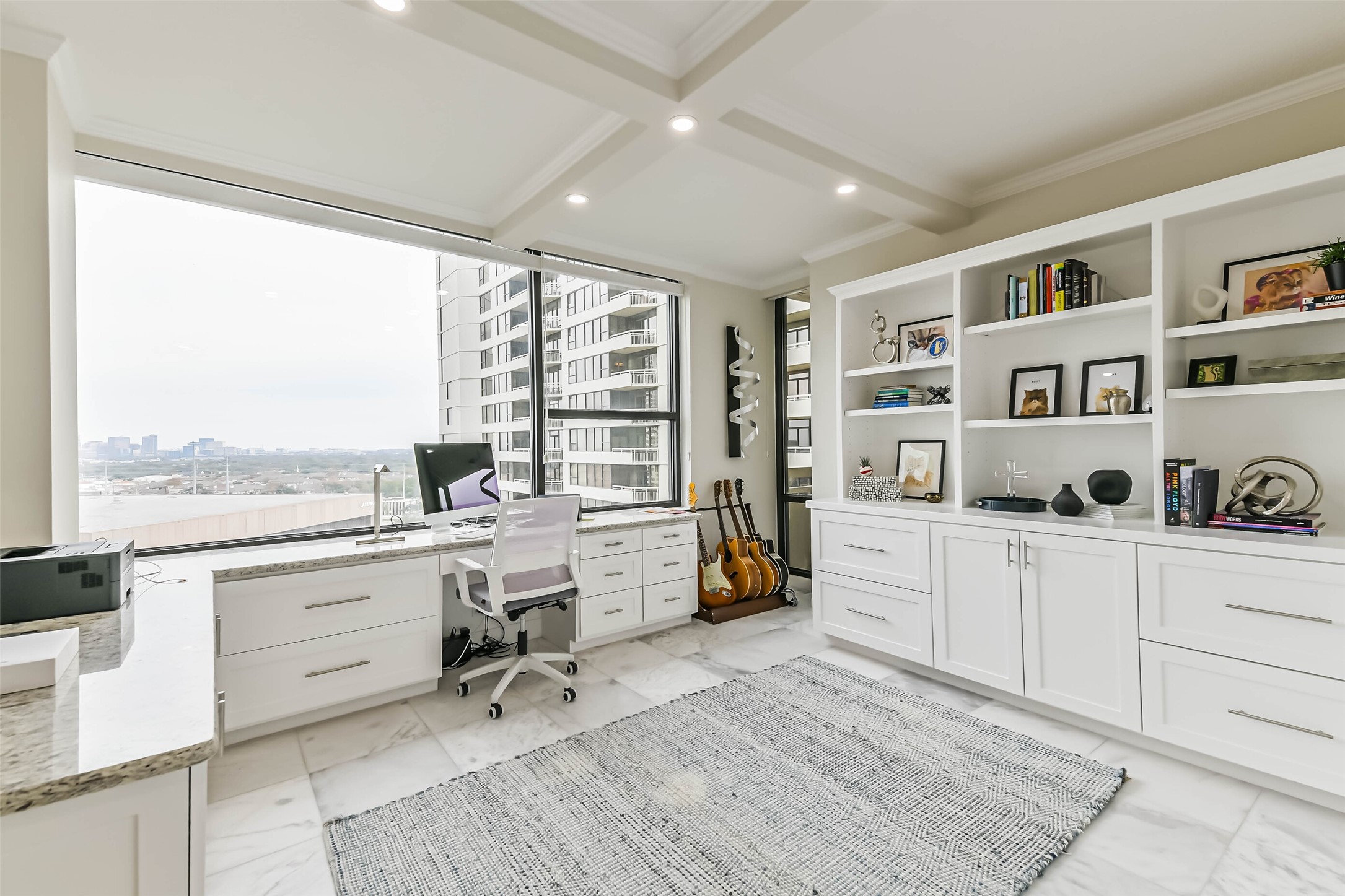 14 Greenway Plaza, Unit 15P Houston, TX 77046 - Photo 14 of 25 a large white kitchen with granite countertop a stove a sink and white cabinets with wooden floor