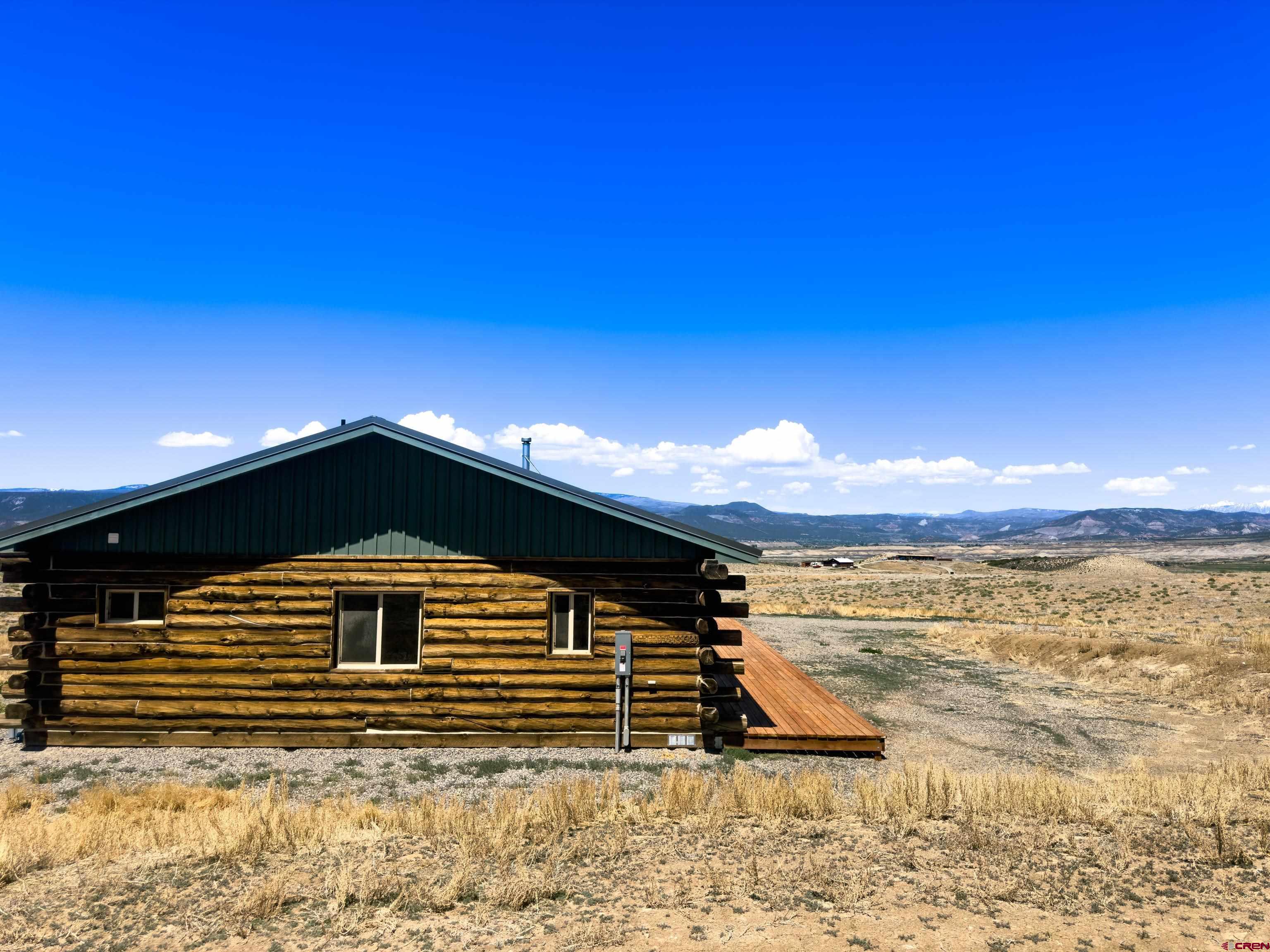 6313 Sagebrush Road Hotchkiss, CO 81419 - Photo 24 of 34 a front view of house with yard