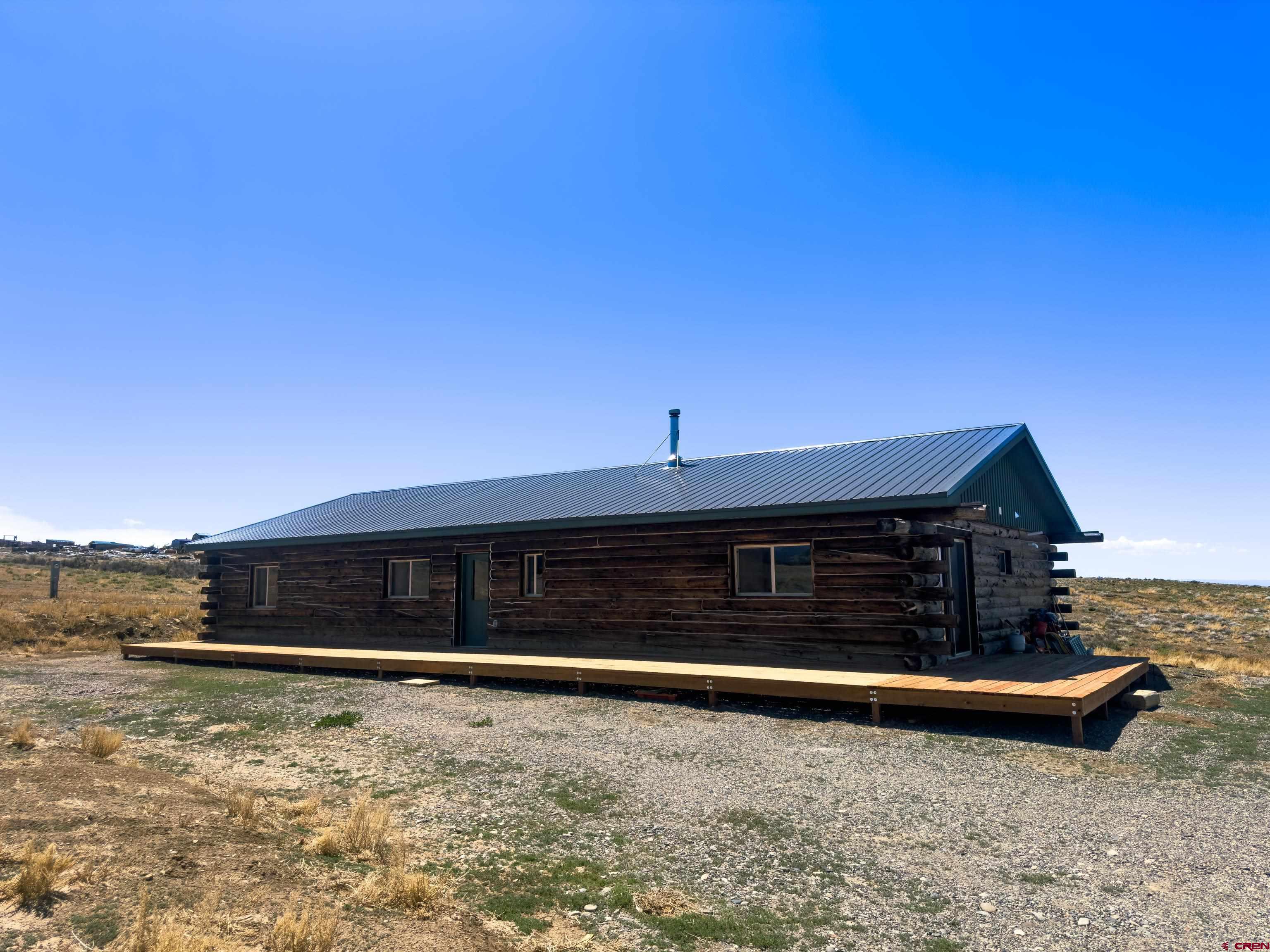 6313 Sagebrush Road Hotchkiss, CO 81419 - Photo 28 of 34 a front view of a house with a garden