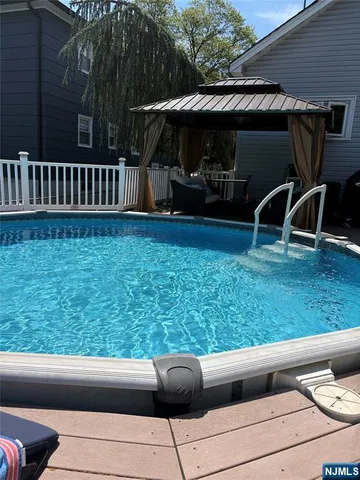 a view of backyard with barbeque grill and furniture