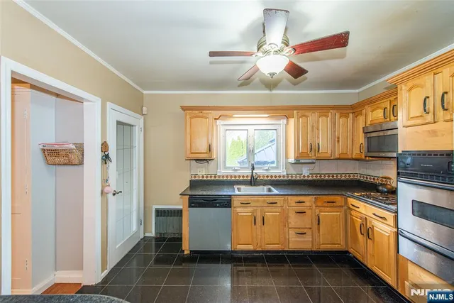 a kitchen with granite countertop white cabinets and white appliances