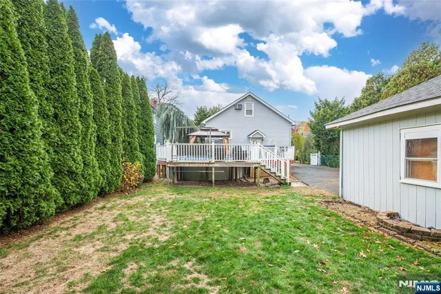 a view of a house with a yard balcony and sitting area