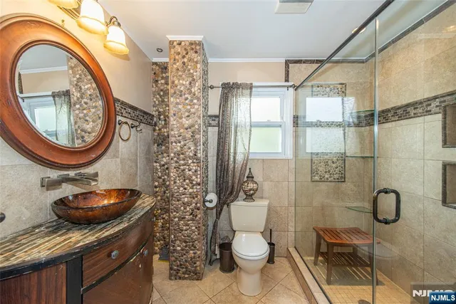 a bathroom with a toilet a sink and a shower