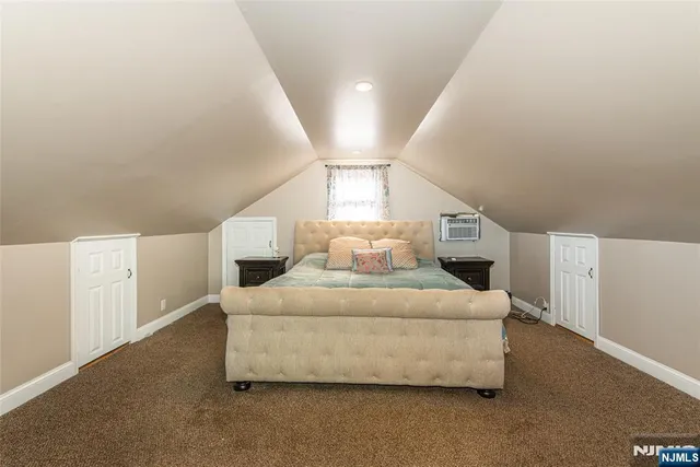 a spacious bedroom with a bed and a window