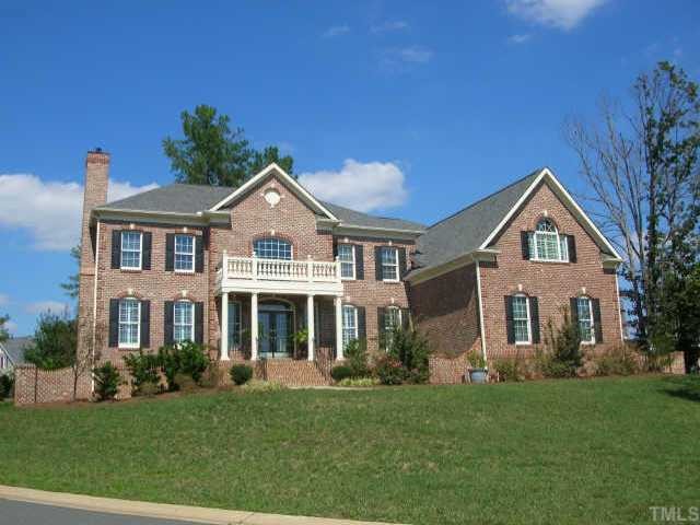 a front view of a house with a yard and porch