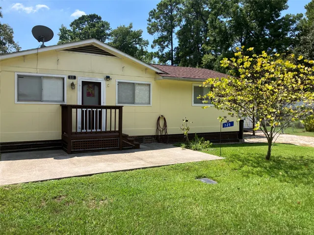 a view of house with backyard