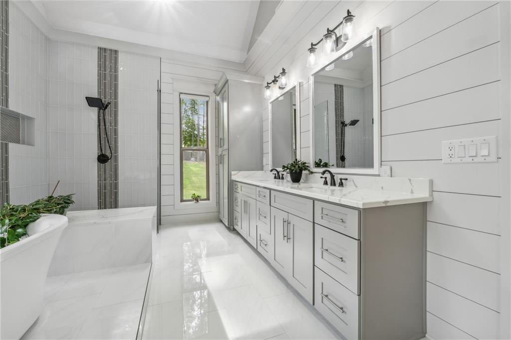 852 Tom Miller Road Bethlehem, GA 30620 - Photo 44 of 68 a bathroom with a double vanity sink and a bathtub