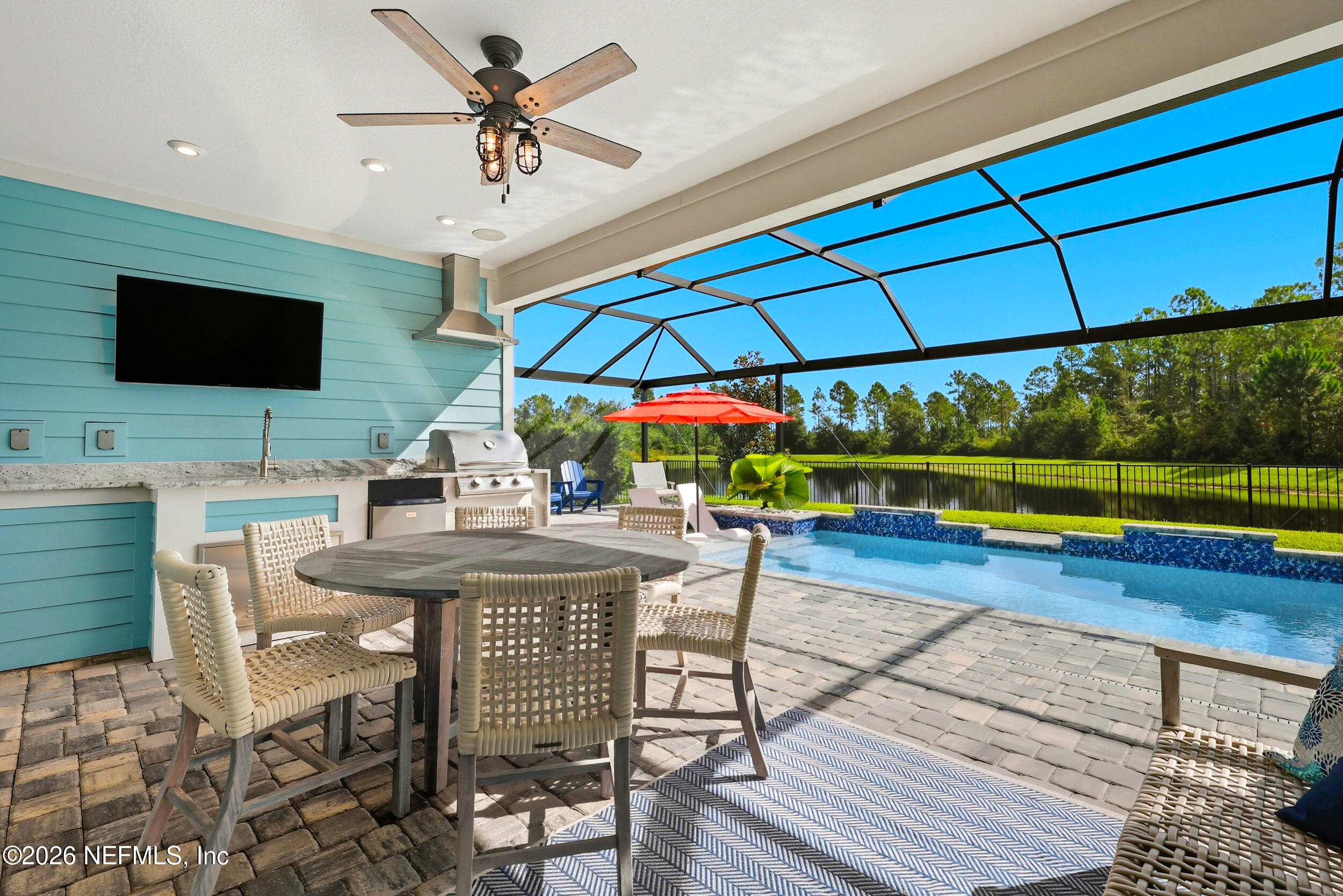a view of a patio with a dining table and chairs under an umbrella
