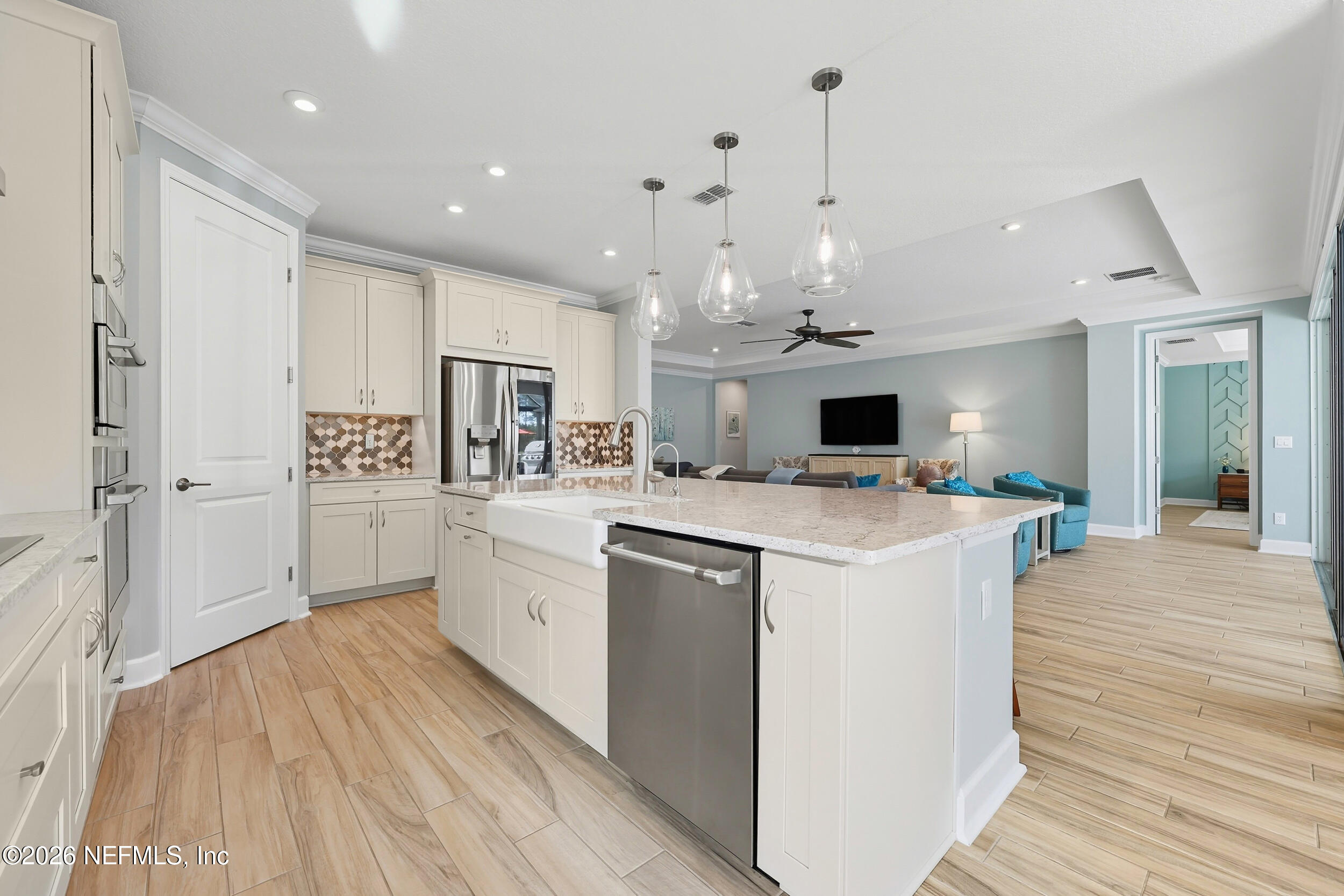 494 Marquesa Circle St. Johns, FL 32259 - Photo 18 of 76 a kitchen with kitchen island a white counter top space stainless steel appliances and cabinets
