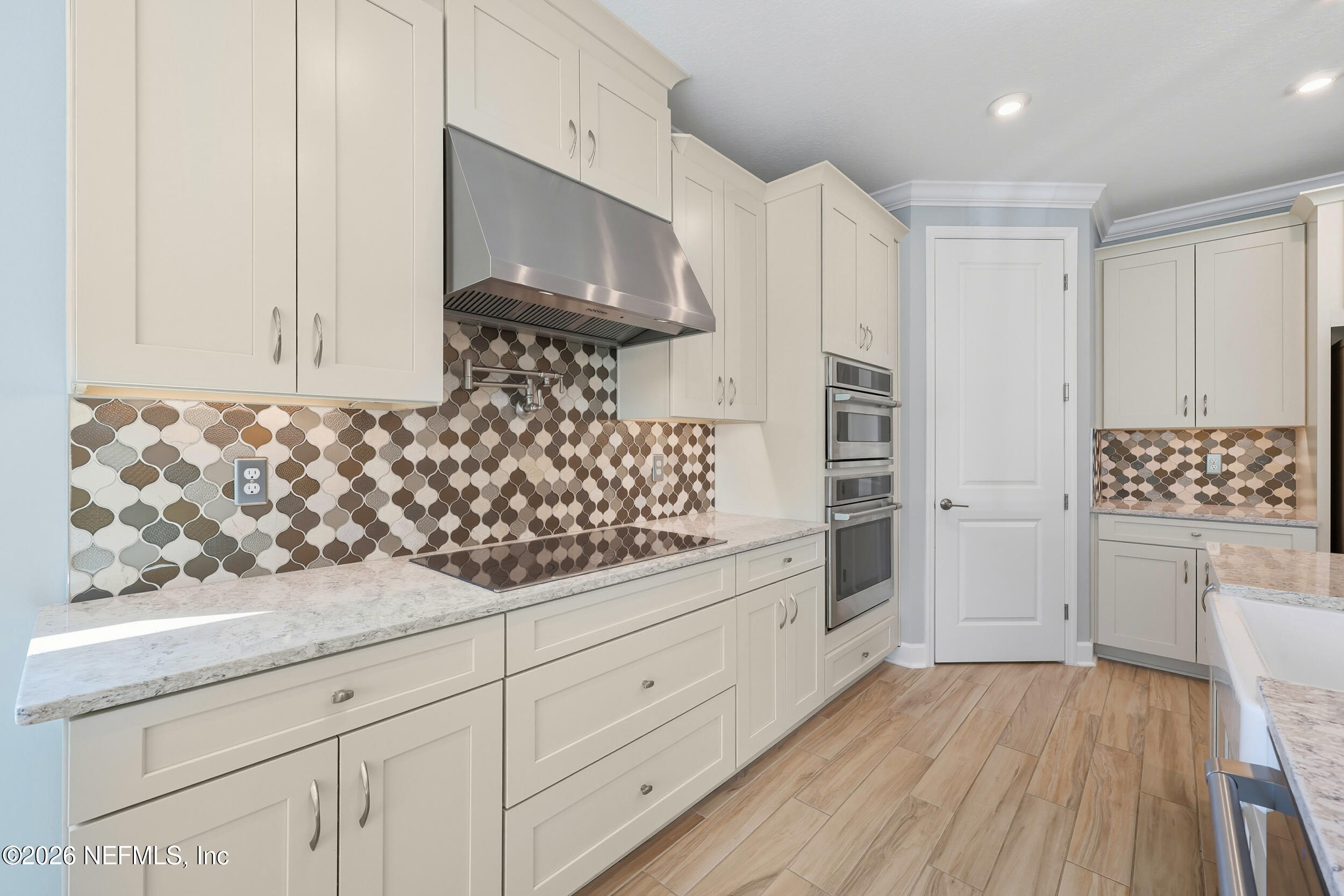 494 Marquesa Circle St. Johns, FL 32259 - Photo 19 of 76 a kitchen with granite countertop white cabinets and white appliances
