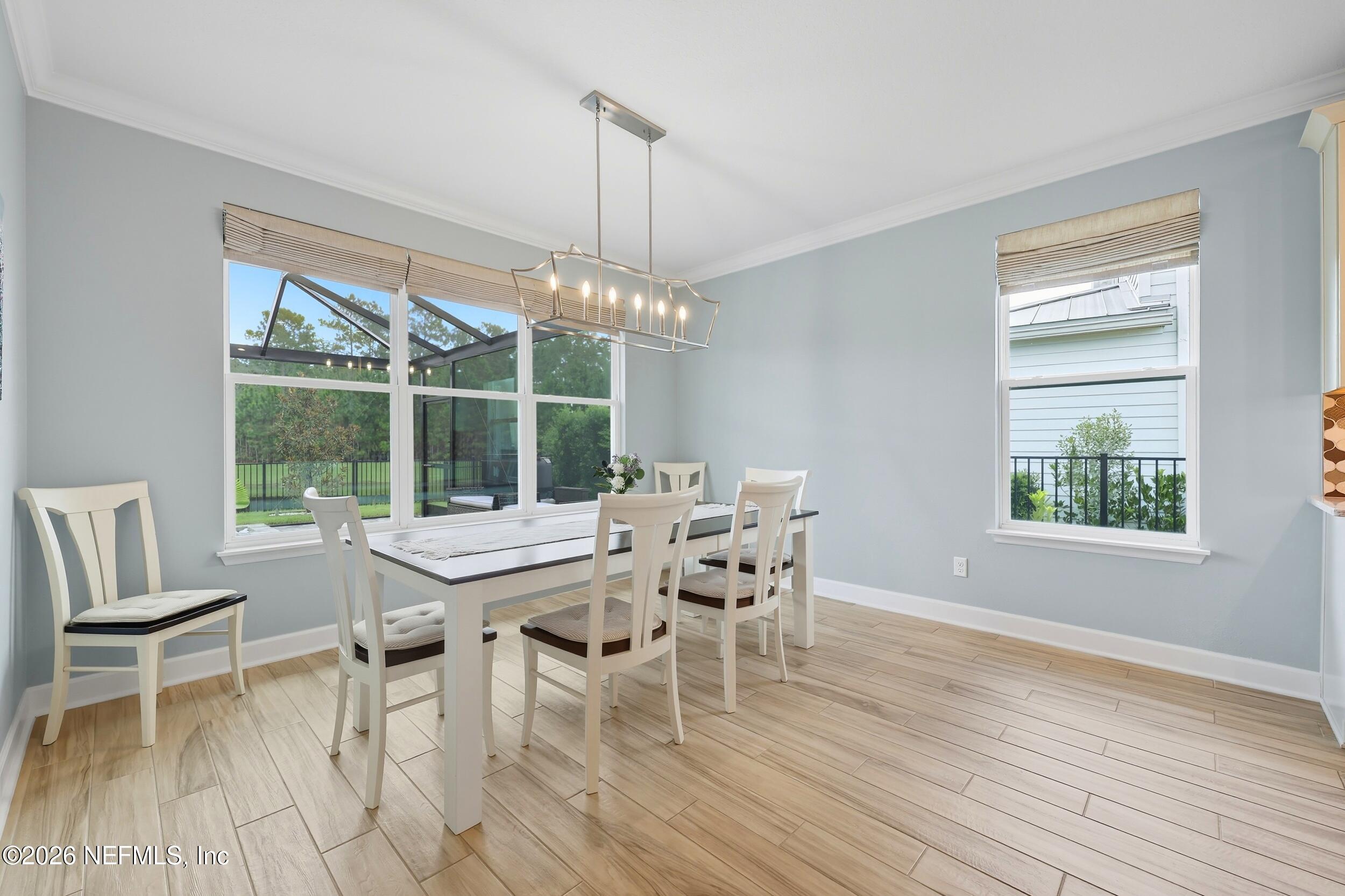 494 Marquesa Circle St. Johns, FL 32259 - Photo 22 of 76 a dining room with furniture a chandelier and wooden floor