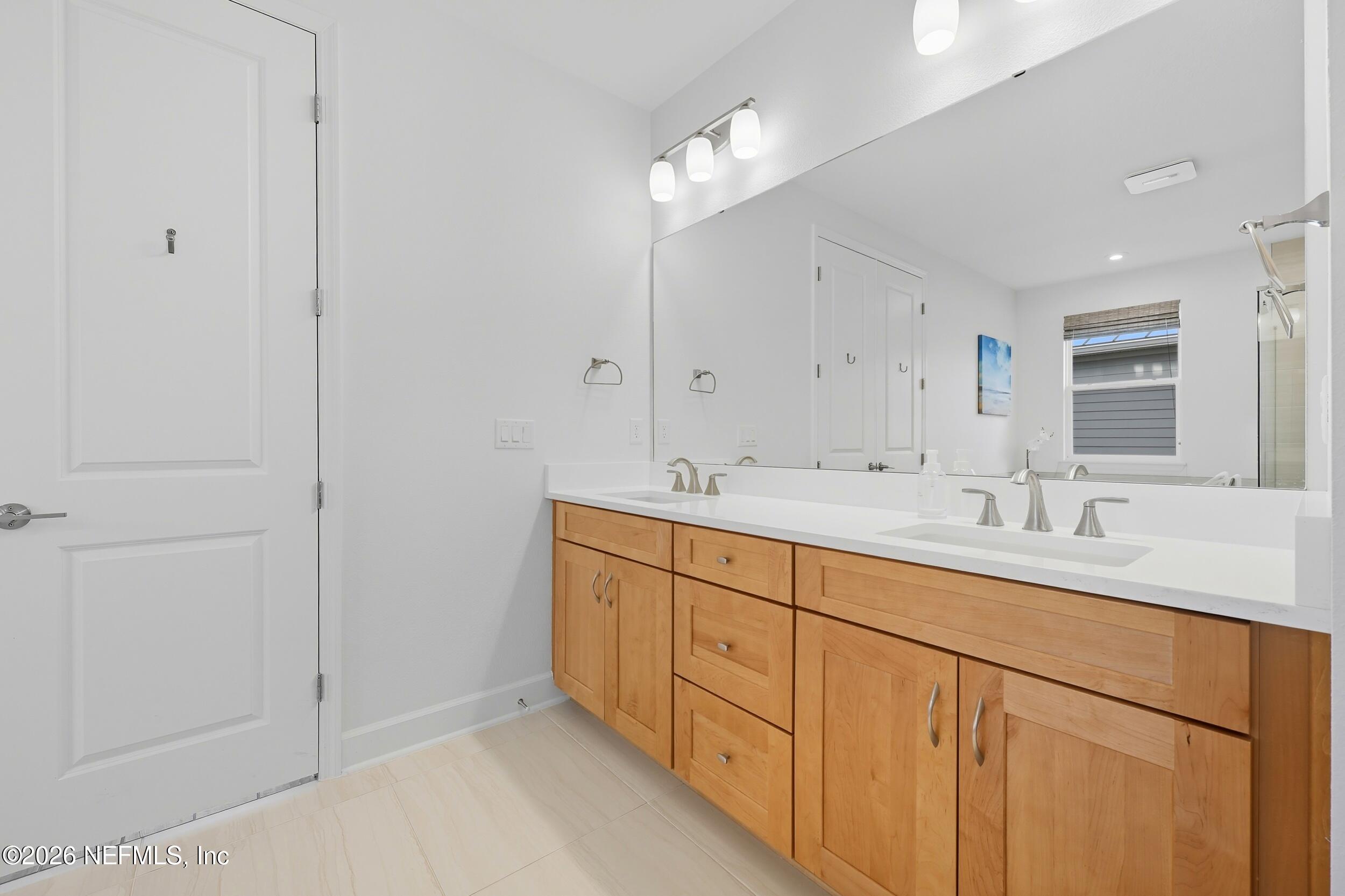 494 Marquesa Circle St. Johns, FL 32259 - Photo 27 of 76 a bathroom with double sink and a mirror