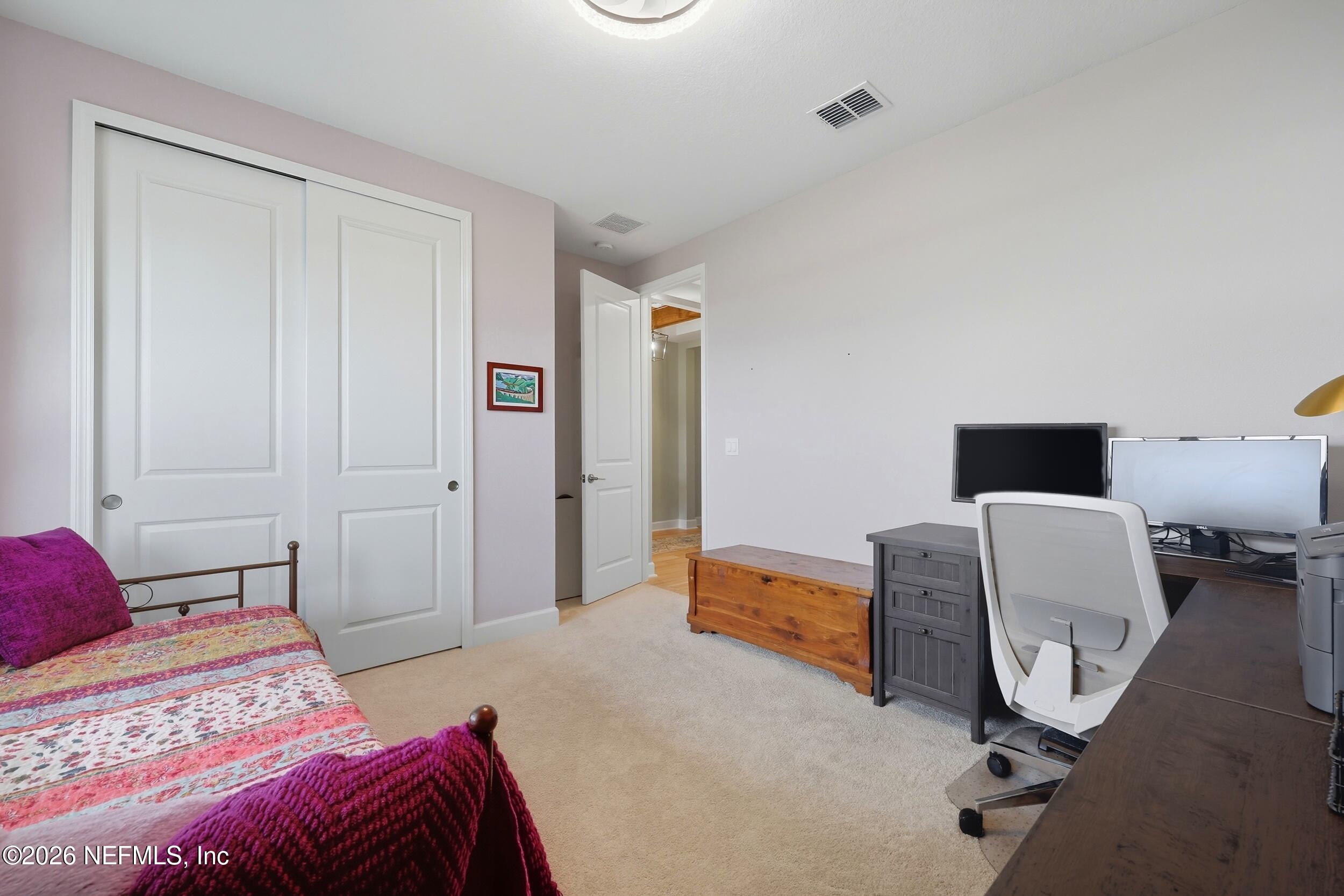 494 Marquesa Circle St. Johns, FL 32259 - Photo 36 of 76 a bedroom with a bed and a chair