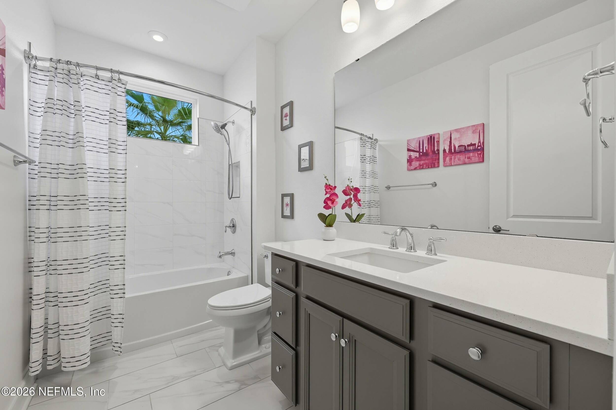 494 Marquesa Circle St. Johns, FL 32259 - Photo 37 of 76 a bathroom with a granite countertop sink mirror vanity and toilet