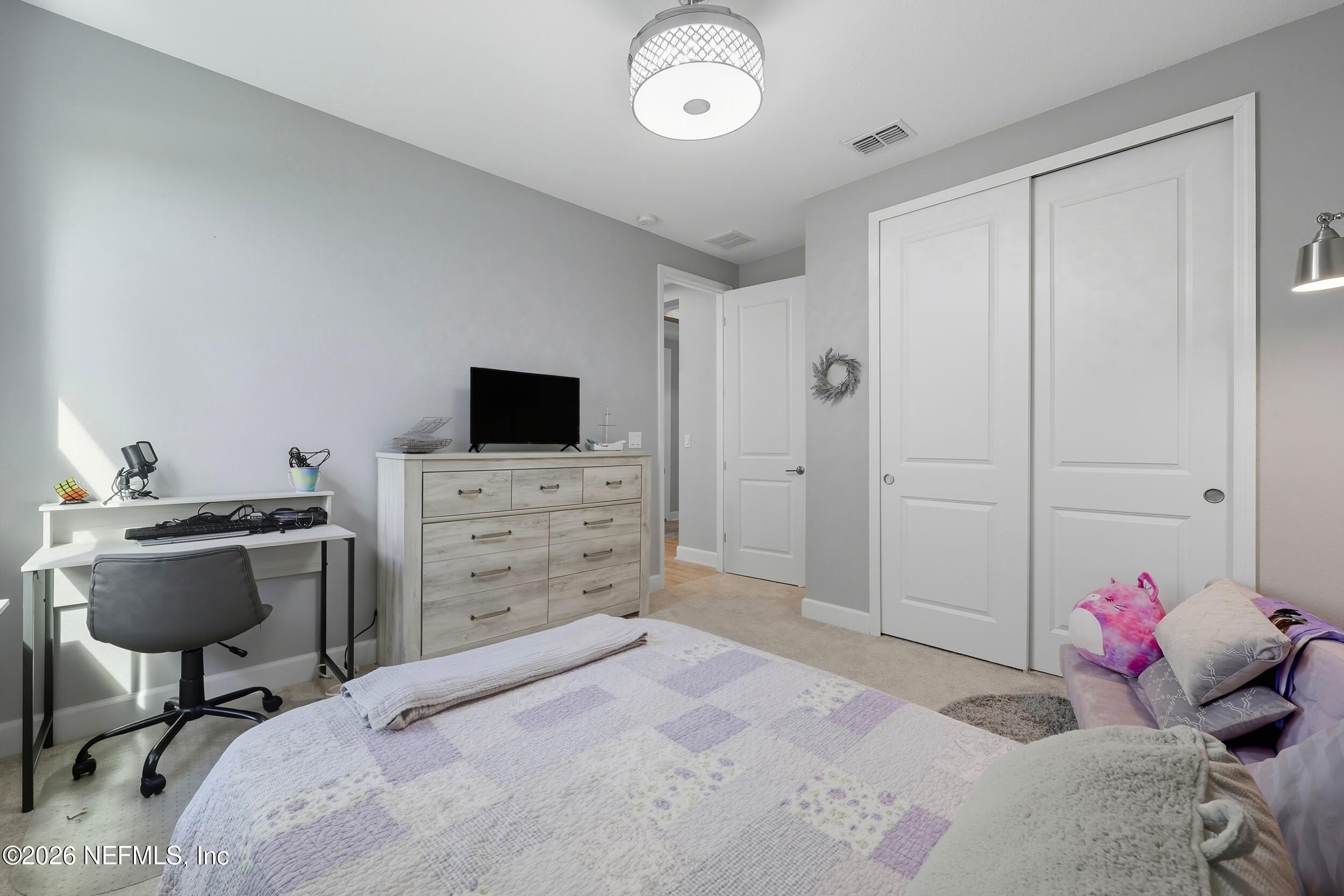 494 Marquesa Circle St. Johns, FL 32259 - Photo 39 of 76 a bedroom with a bed and a chair in it