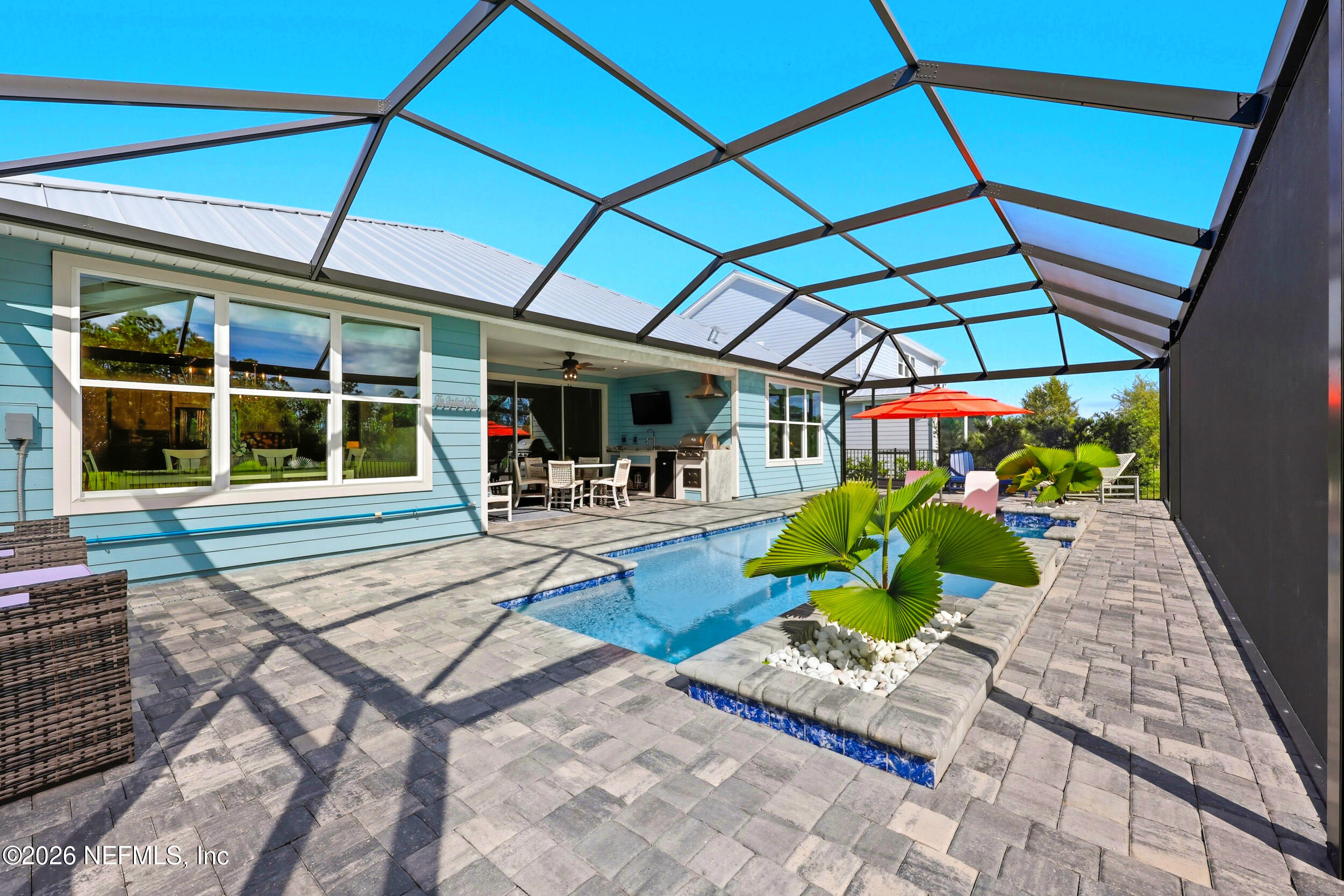 494 Marquesa Circle St. Johns, FL 32259 - Photo 47 of 76 a view of a patio with a table and chairs under an umbrella