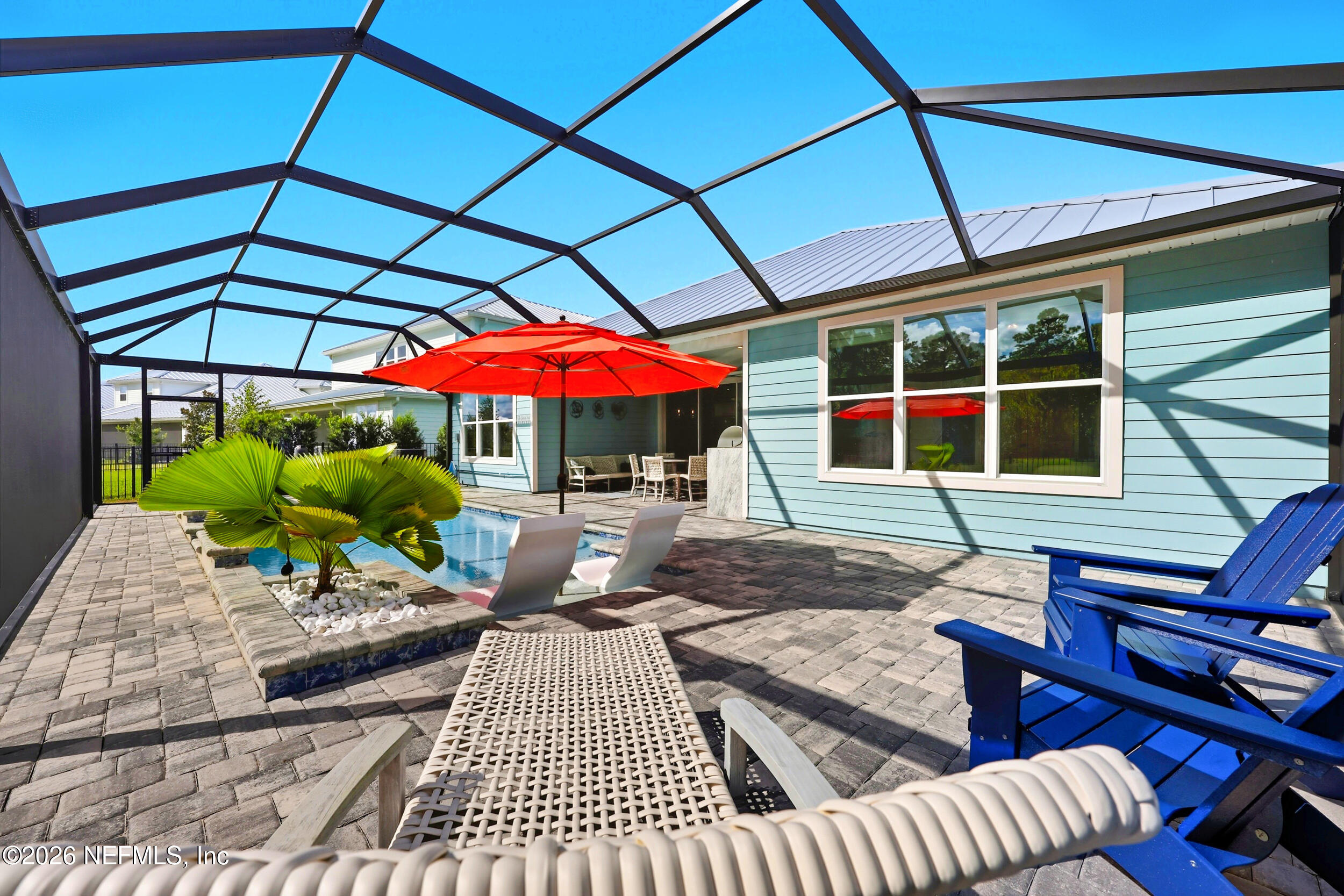 494 Marquesa Circle St. Johns, FL 32259 - Photo 48 of 76 a view of a patio with a table and chairs under an umbrella