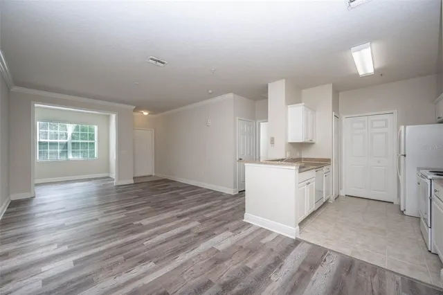 a kitchen with granite countertop a stove and a refrigerator