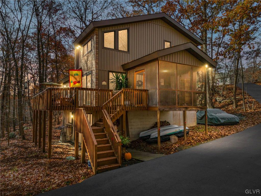 3215 Cherry Ridge Road Bushkill, PA 18324 - Photo 1 of 50 a view of a wooden house with a large trees and wooden fence