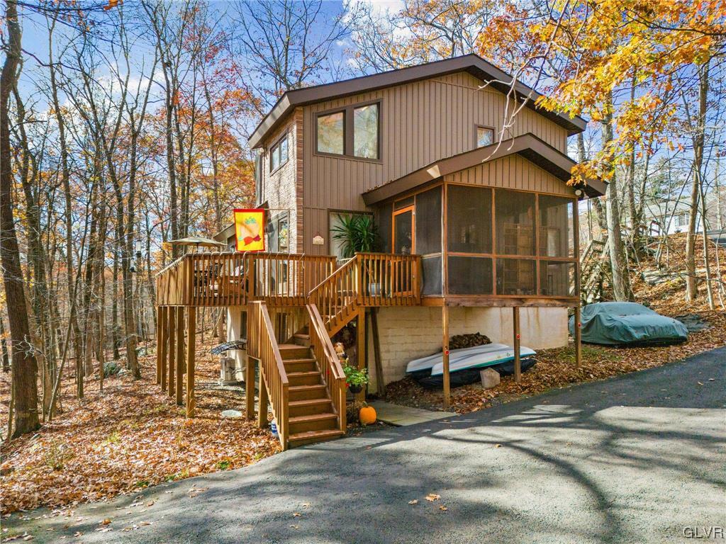 3215 Cherry Ridge Road Bushkill, PA 18324 - Photo 2 of 50 a view of a wooden house with large trees and wooden fence