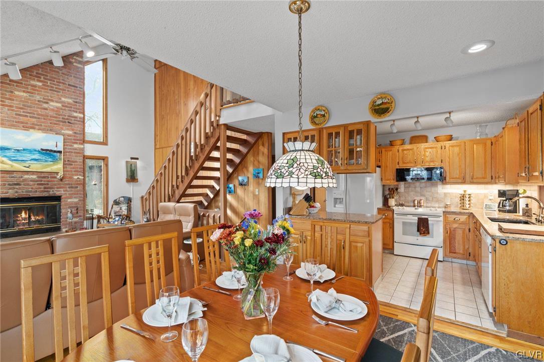 3215 Cherry Ridge Road Bushkill, PA 18324 - Photo 23 of 50 a view of a dining room with furniture a chandelier and wooden floor