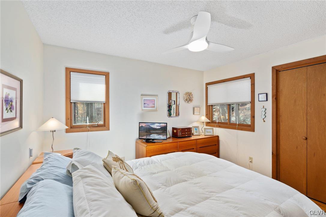 3215 Cherry Ridge Road Bushkill, PA 18324 - Photo 28 of 50 a bedroom with a large bed and a chandelier