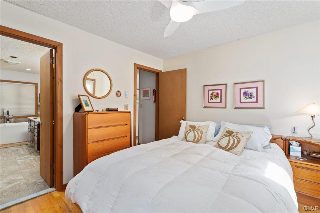 3215 Cherry Ridge Road Bushkill, PA 18324 - Photo 29 of 50 a bedroom with a bed and a chandelier