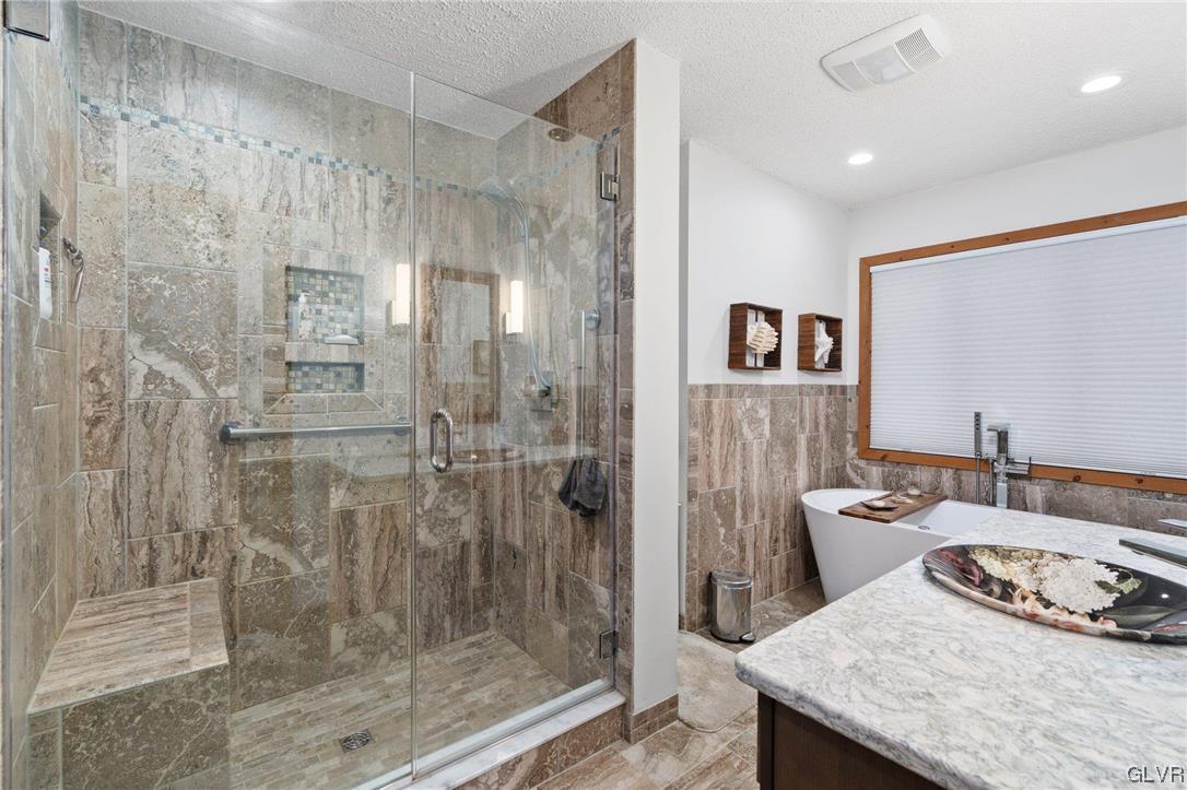 3215 Cherry Ridge Road Bushkill, PA 18324 - Photo 30 of 50 a bathroom with a granite countertop shower a sink and a mirror