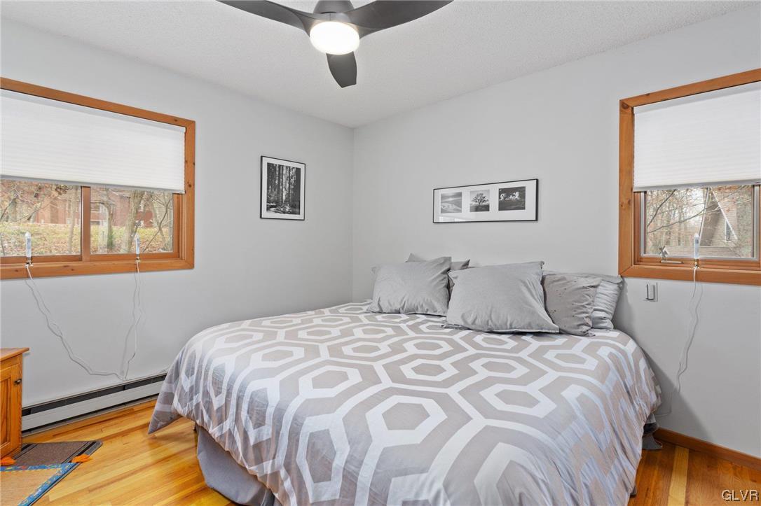 3215 Cherry Ridge Road Bushkill, PA 18324 - Photo 37 of 50 a bedroom with a bed and a painting on the wall