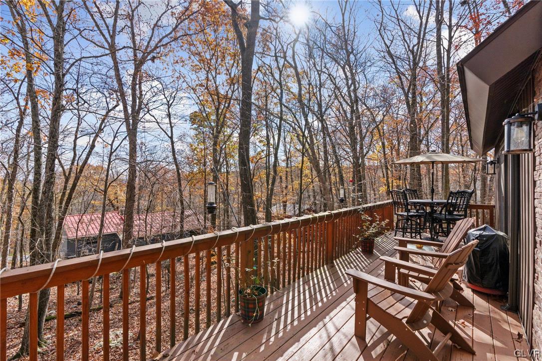 3215 Cherry Ridge Road Bushkill, PA 18324 - Photo 9 of 50 a view of a balcony with wooden floor and fence and a trees