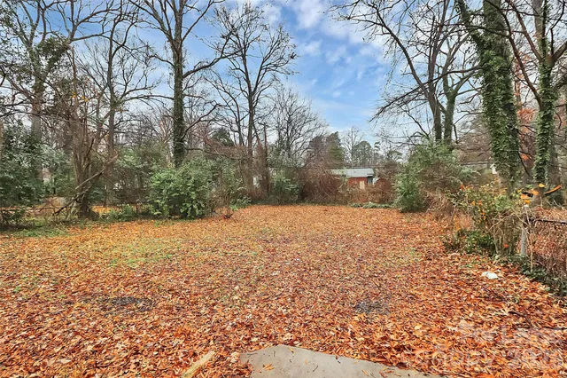 a backyard of a house with large trees