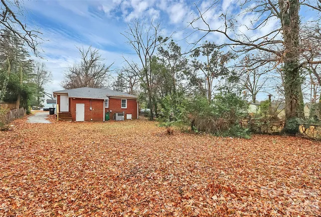 a view of a house with a yard covered in snow