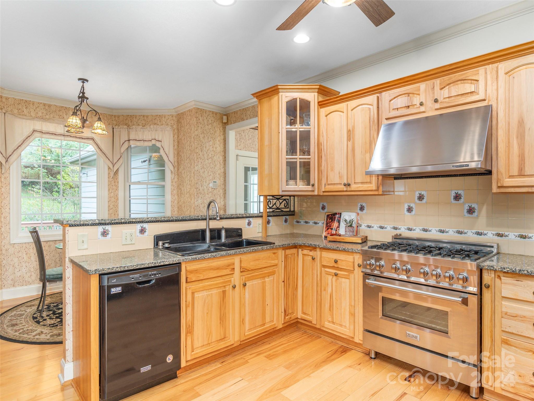 4113 Beaverdam Road Canton, NC 28716 - Photo 14 of 44 a kitchen with stainless steel appliances granite countertop a stove sink and cabinets