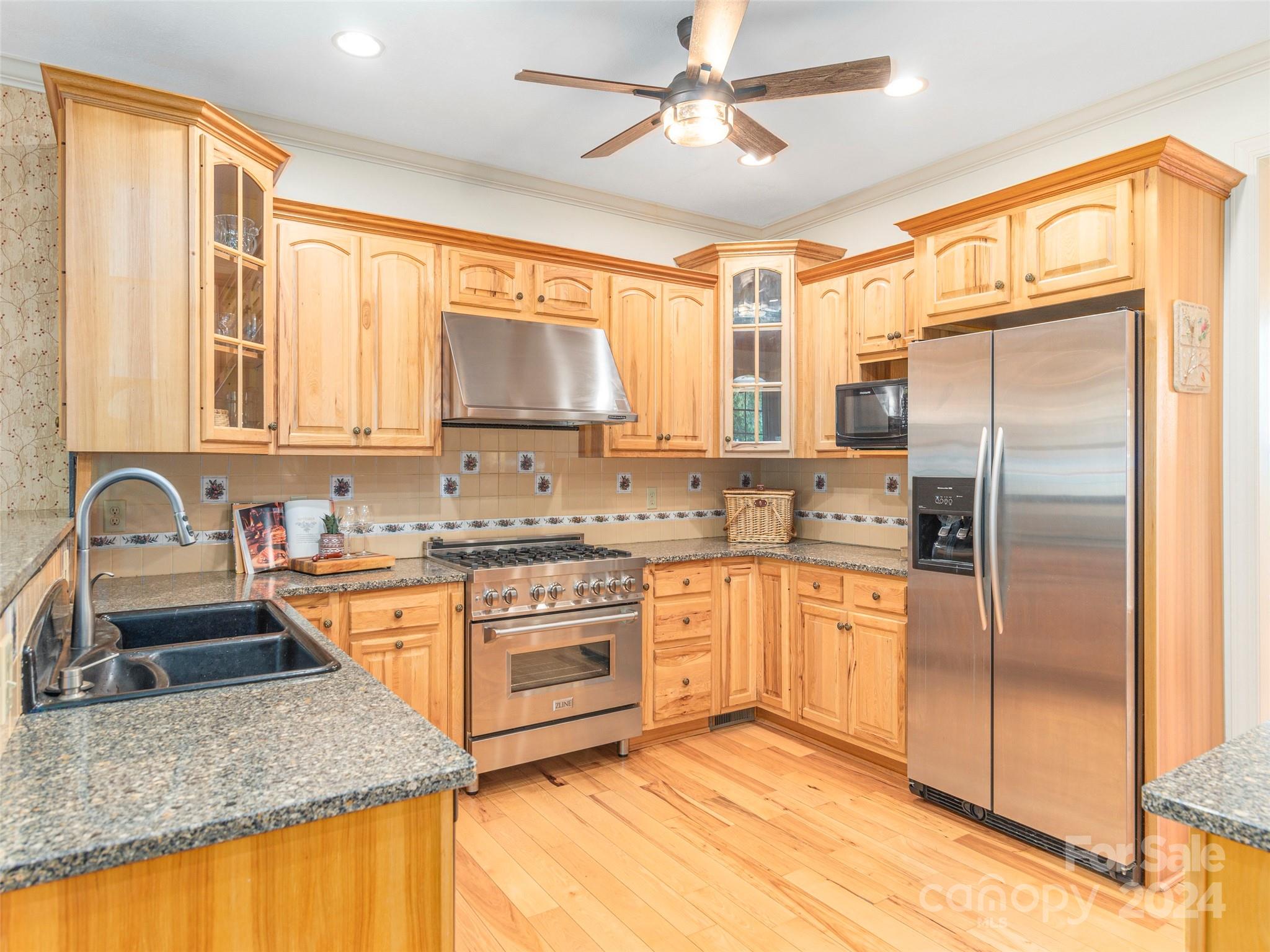 4113 Beaverdam Road Canton, NC 28716 - Photo 15 of 44 a kitchen with stainless steel appliances granite countertop a sink stove and refrigerator