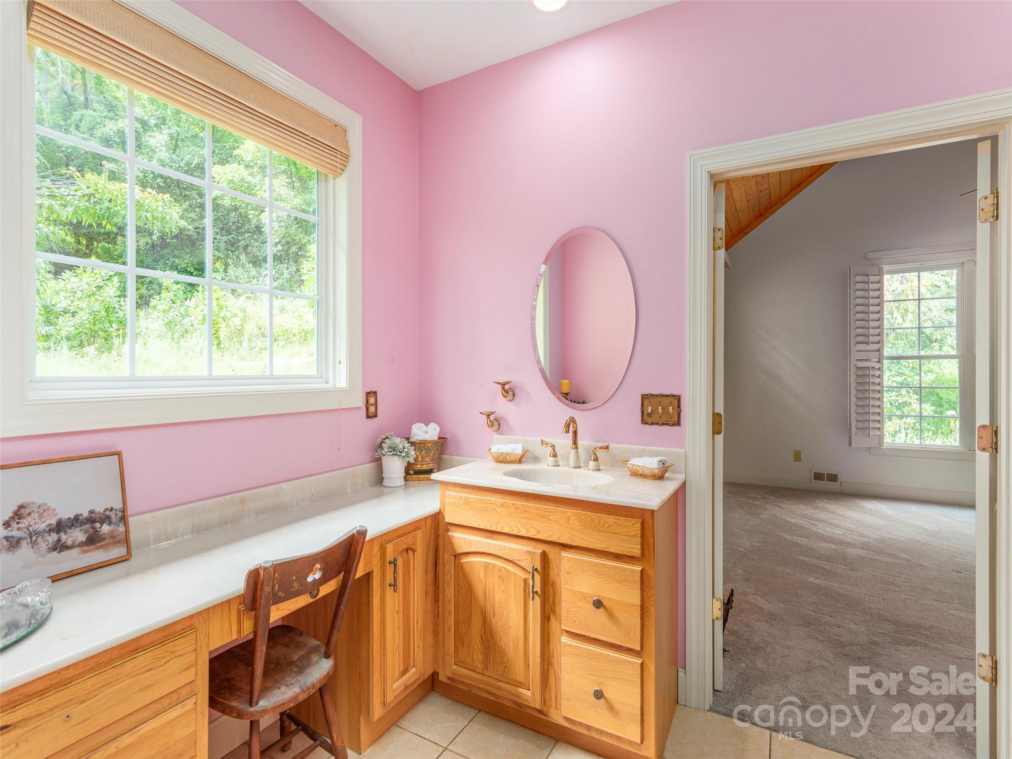 4113 Beaverdam Road Canton, NC 28716 - Photo 19 of 44 a spacious bathroom with a granite countertop sink a mirror and a window