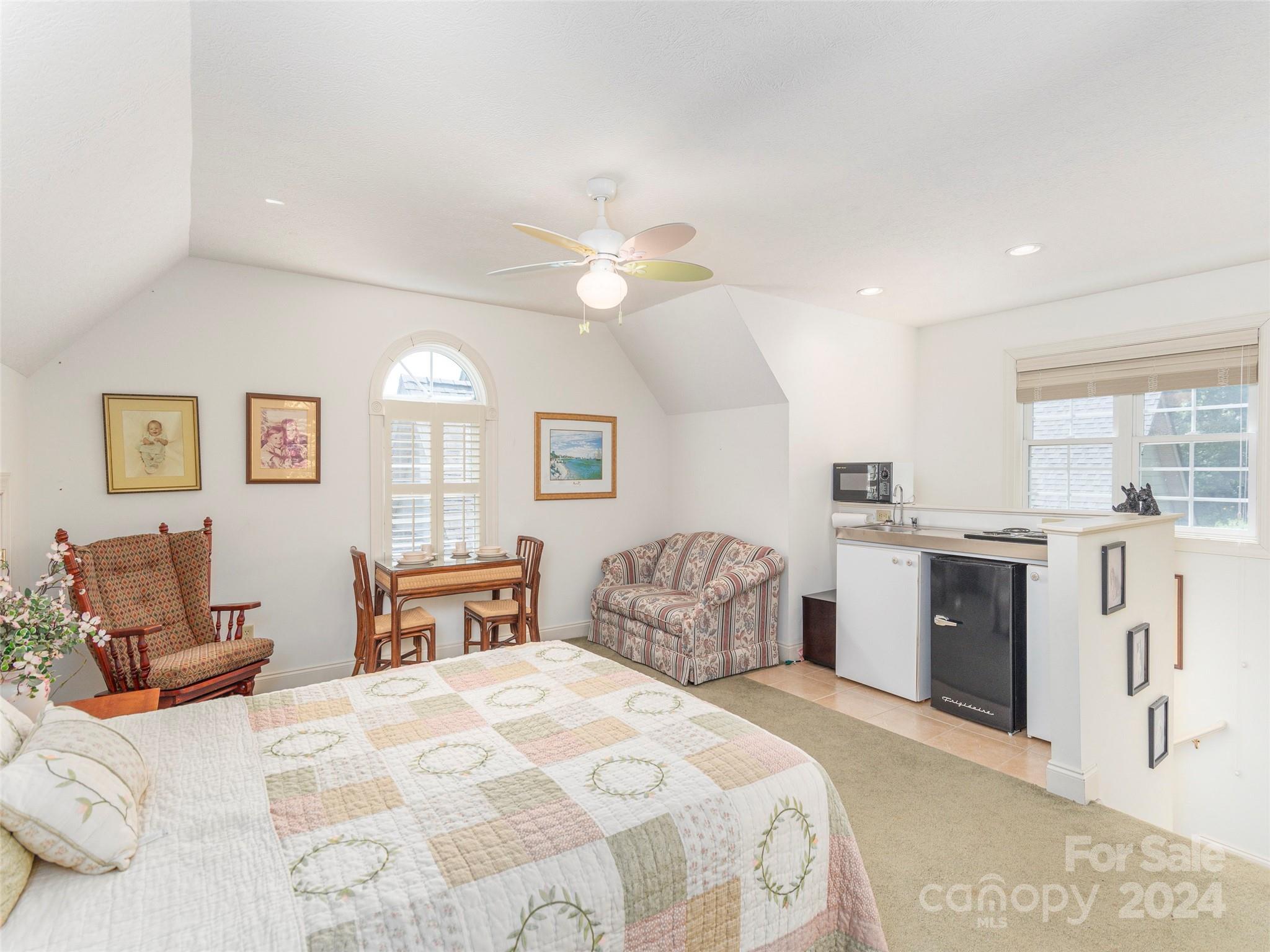 4113 Beaverdam Road Canton, NC 28716 - Photo 25 of 44 a spacious bedroom with a bed and a chandelier