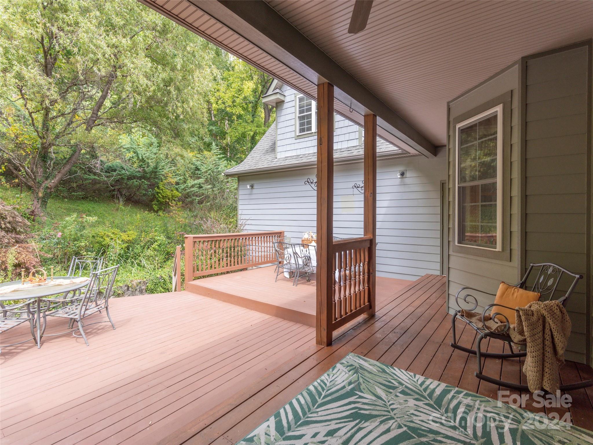 4113 Beaverdam Road Canton, NC 28716 - Photo 31 of 44 a balcony with wooden floor table and chairs