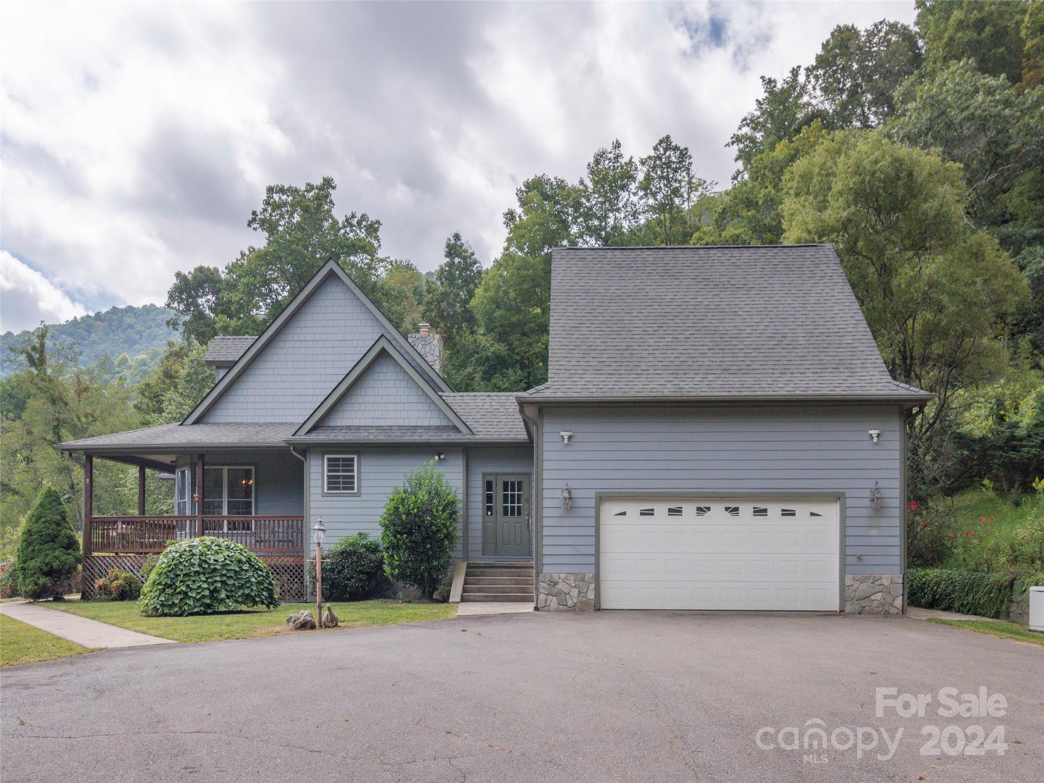 4113 Beaverdam Road Canton, NC 28716 - Photo 40 of 44 a front view of a house with a garden and plants