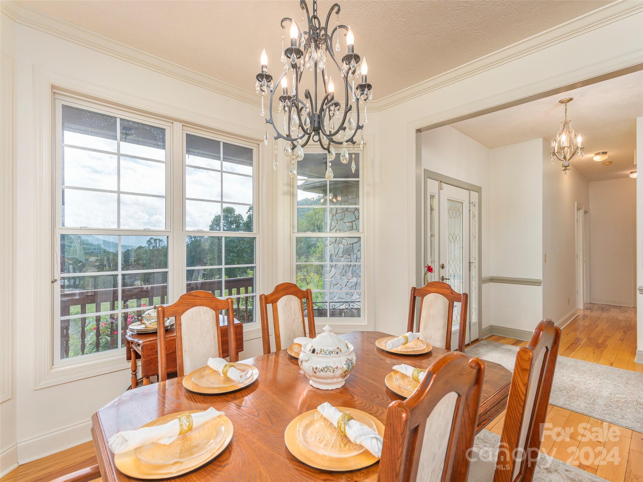 4113 Beaverdam Road Canton, NC 28716 - Photo 8 of 44 a dining room with furniture a large window and wooden floor