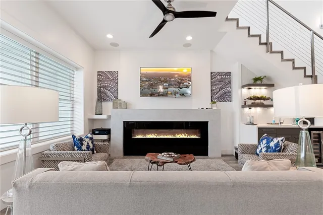 a living room with furniture a fireplace and a flat screen tv