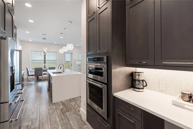 a kitchen with a sink stainless steel appliances and cabinets