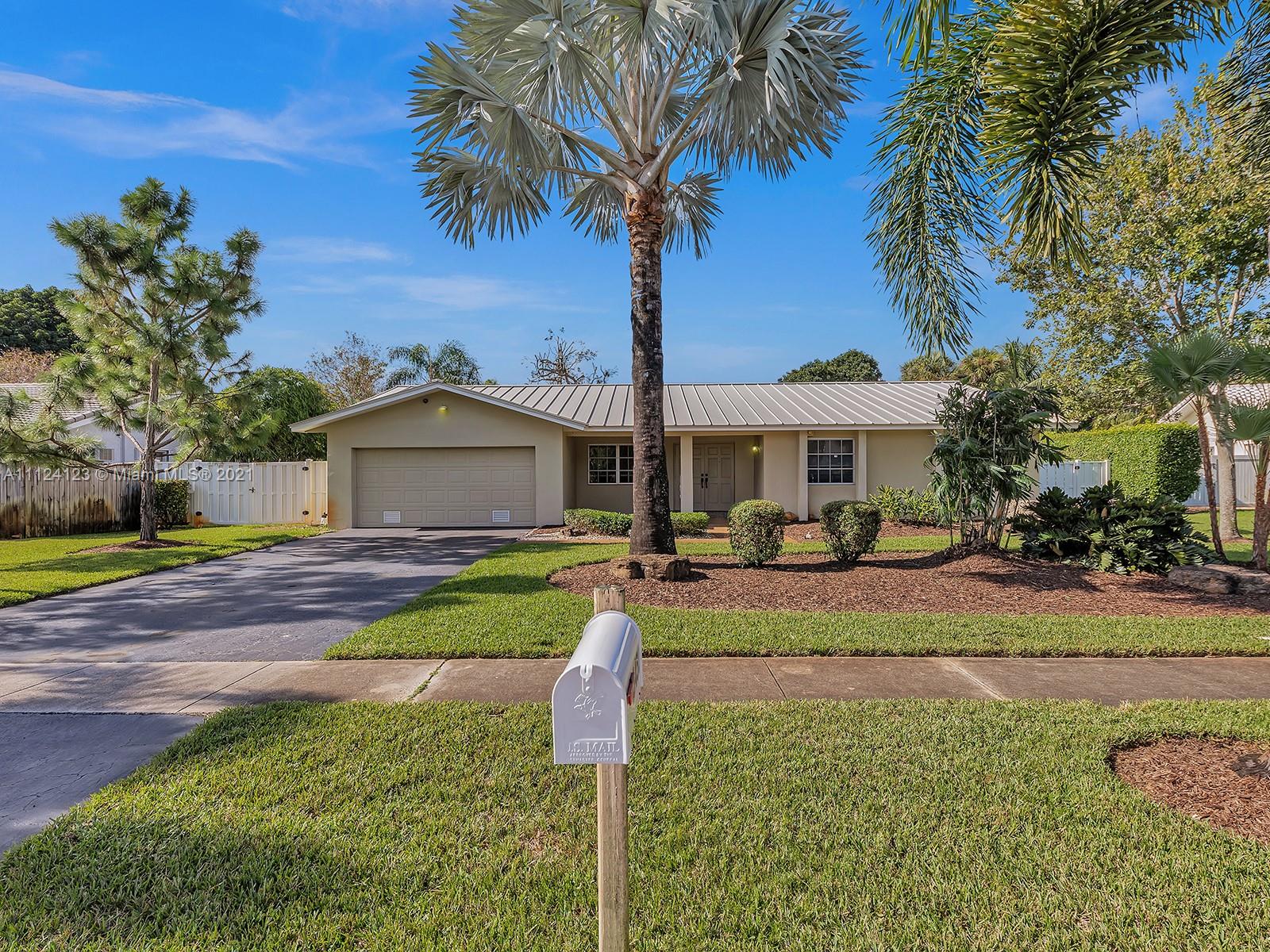 a front view of a house with garden and porch