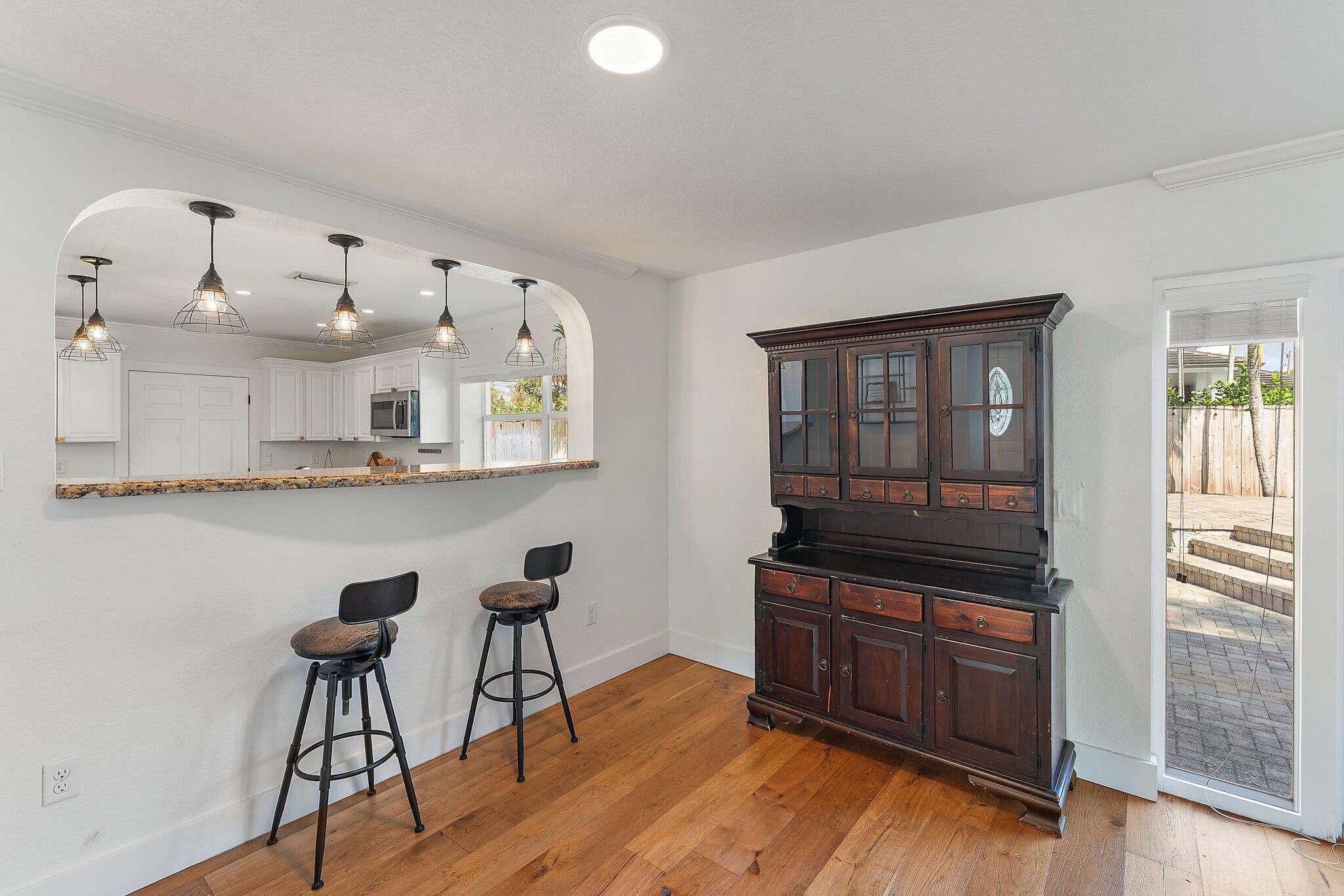 5692 Pennock Point Road Jupiter, FL 33458 - Photo 15 of 51 a kitchen with granite countertop a stove a sink and a wooden floors