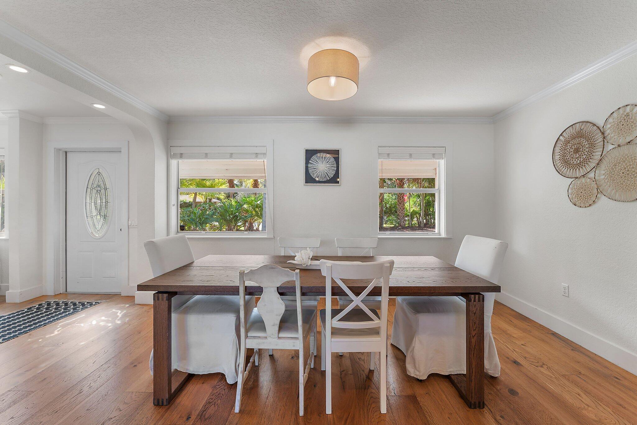 5692 Pennock Point Road Jupiter, FL 33458 - Photo 19 of 51 a view of a dining room with furniture and wooden floor