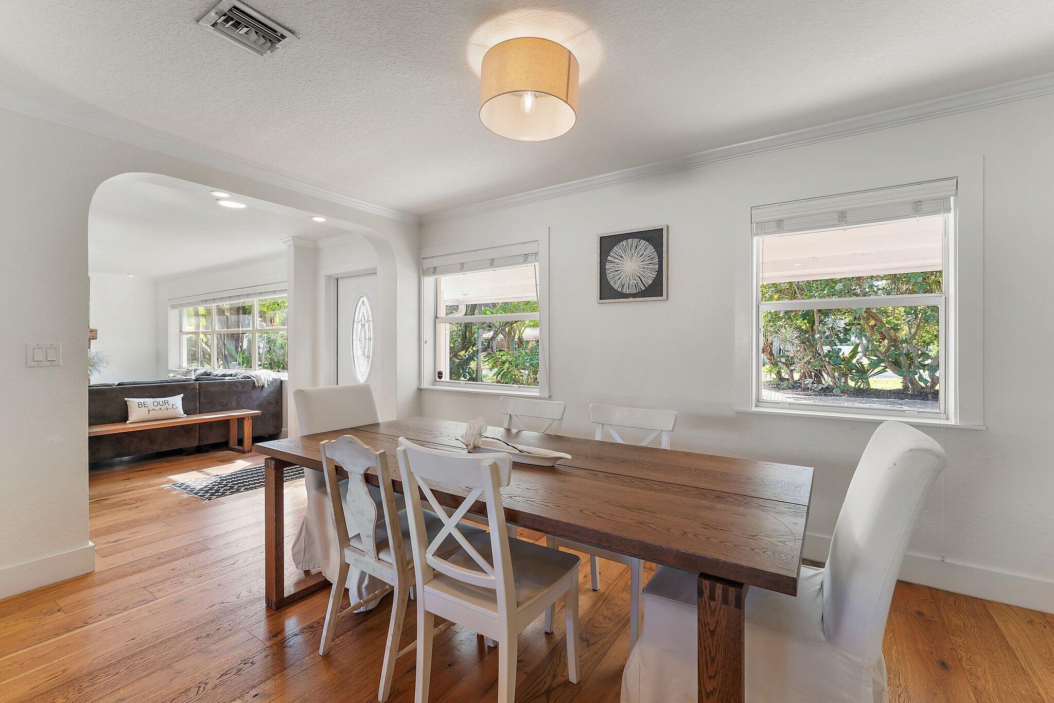 5692 Pennock Point Road Jupiter, FL 33458 - Photo 20 of 51 a view of a dining room with furniture window and wooden floor