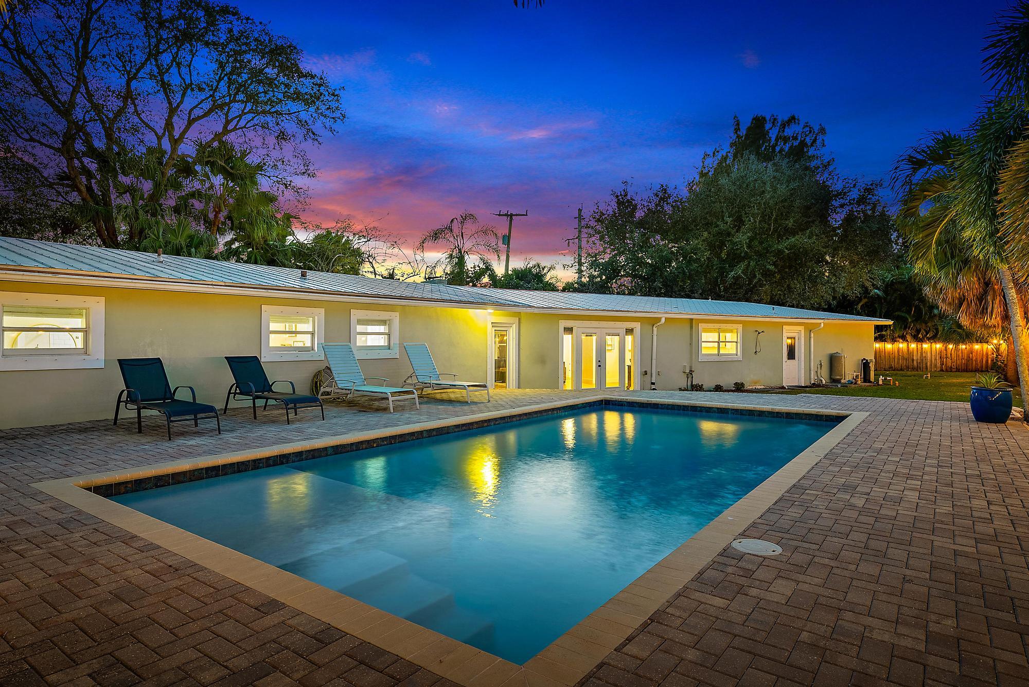 5692 Pennock Point Road Jupiter, FL 33458 - Photo 43 of 51 a view of swimming pool with outdoor seating and yard in the back