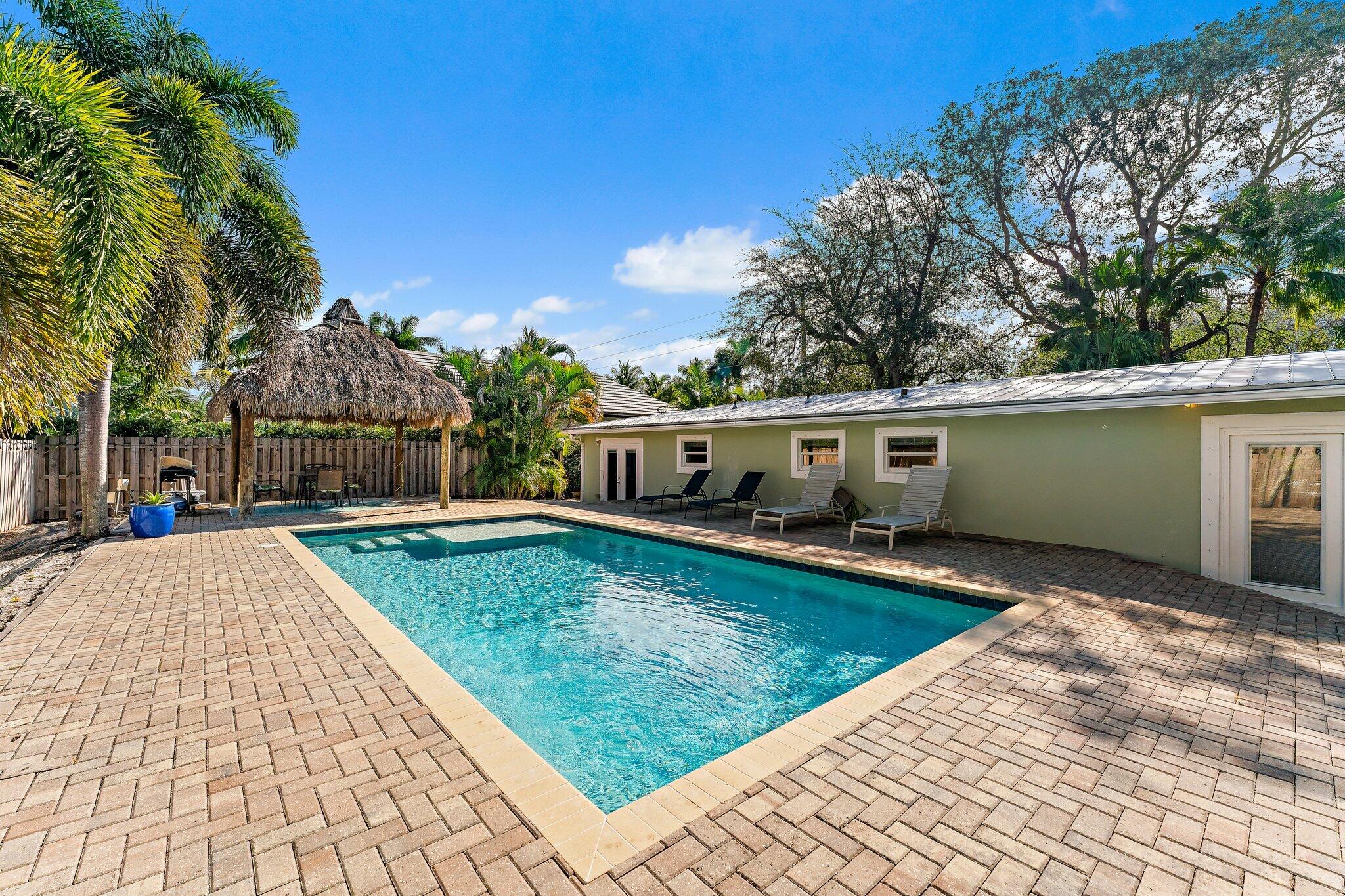 5692 Pennock Point Road Jupiter, FL 33458 - Photo 44 of 51 a front view of house with yard space and seating