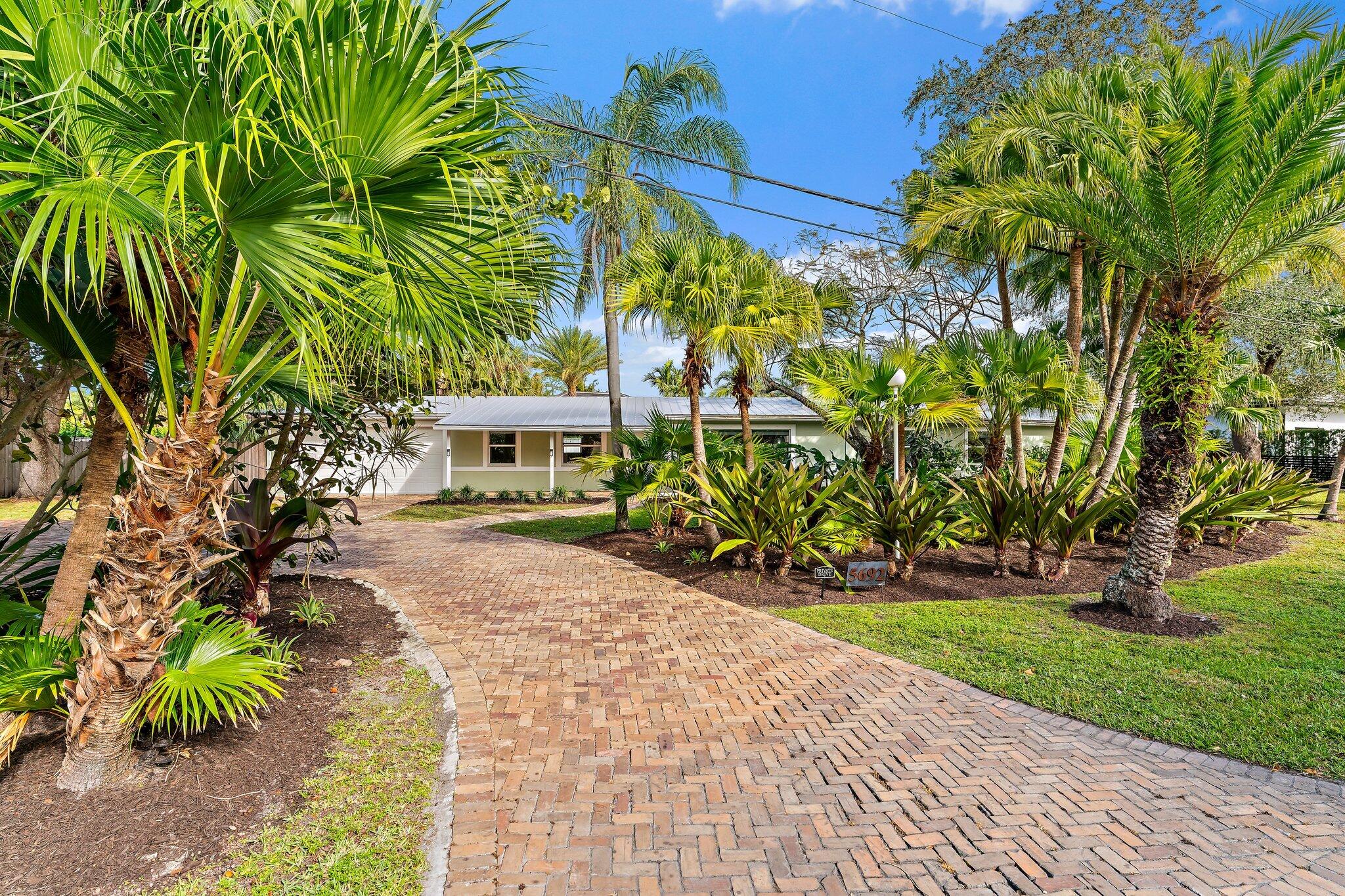 5692 Pennock Point Road Jupiter, FL 33458 - Photo 47 of 51 a front view of a house with a yard